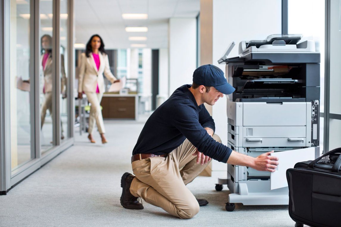 PrintFix.Space AMC technician performing scheduled onsite printer maintenance